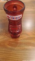 Front view of the red glass beer mug shaped like a hockey skate with Molson Canadian logo decal.