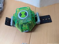 Top view showing the green transparent lab cover with Ben 10 Omnitrix logo and gray handles