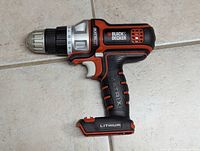Side angle view of the cordless drill highlighting the chuck, torque settings, and handle design.