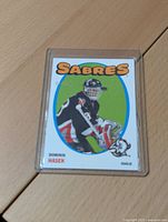 Front of the Dominik Hasek hockey card showing player image, team name 'Sabres', and player name with position.
