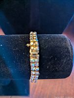 Side view of Sherman women's bracelet showing double rows of clear rhinestones on gold-tone metal.