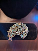 Front view of Sherman women's brooch showing iridescent and clear rhinestones in leaf design