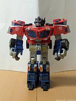 Front view of the Transformers Cybertron Optimus Prime figure in a standing pose showing detailed paint and articulation.