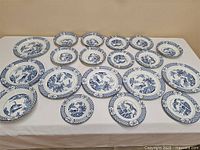 Overview of 19-piece set arranged on table showing plates and bowls