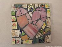 Full view of the 5.5 inch square mosaic artwork featuring a central heart motif composed of broken crockery shards with varied patterns including floral and geometric elements.