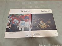 Front view of both Gauguin and Rembrandt art books showing covers with artwork and titles