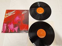 Overview of album cover and two vinyl records placed on table