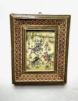 Full front view of the framed miniature Persian gouache painting featuring three men playing polo on horseback, set in detailed Khatam marquetry frame with geometric star patterns.
