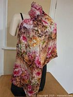 Silk scarf displayed on a mannequin showing full floral pattern and drape.