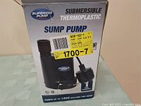 Image of the original box showing brand Superior Pump and sump pump details, including pumping capacity of up to 1800 gallons per hour.