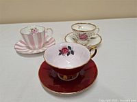 Three British vintage teacups each with matching saucers, various floral and striped designs