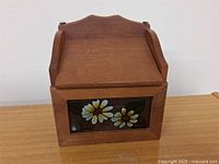 Wooden box with lid and colored stained glass front panel showing flowers and leaves