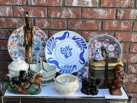 Overview photo showing all items in the lot displayed on a surface against a brick wall backdrop.