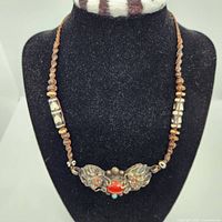 Full front view of necklace displayed on black bust