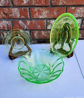 Three items shown together on easels: round small plate, oval Rupert dish, and scalloped bowl