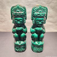 Pair of green glazed Aztec style decanter bottles front view