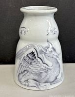 Full view of pottery jar showing detailed dragon illustration in black on white glazed pottery