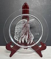 Front view of the Lalique crystal plate on a display stand showcasing the frosted bird design and date 1973.