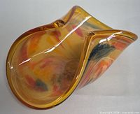 Image of the Murano art glass bowl showing the freeform shape, yellow, orange, red, and blue swirls with glossy finish.