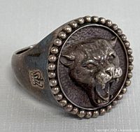 Angled view of ring showing panther head face and side profile with hallmark