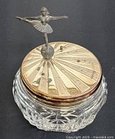 Crystal and silver plated ballerina musical box powder jar showing silver lid details and ballerina figurine on globe.