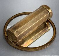 Lipstick case faceted gold-tone metal viewed separately, hinged and slid open.