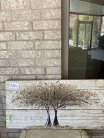 Full view of tree art painting showing two stylized trees with textured branches and leaves on wooden plank background.
