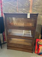 Front view of the oak barrister bookcase showing three glass-front shelves stacked vertically.