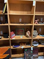 Full frontal view showing the bookshelf's five shelves and three vertical compartments, some containing decorative items (not included in sale).