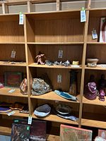 Front view of bookshelf showing five shelves with various art pieces (not included) placed to demonstrate shelf space.