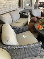 Patio setup showing the 2-seater sofa and one armchair with cushions