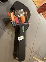 Yamaha hard shell guitar case with guitar method books on top