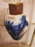 Side view of the Adderley floral porcelain vase showing flow blue floral design and gold accented neck.