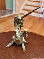 Front view of Herend porcelain unicorn figurine in green fishnet design with gold accents, standing on hind legs