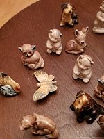 Wade Red Rose Tea animal whimsies arranged on surface, showing various animal types including cats, rabbits, birds, butterfly, dog with detailed hand-painting and glazing