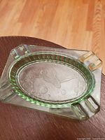 Top-down view showing the full shape and the diver and bubbles design in the center of the ashtray.