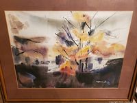 Full view of the framed watercolor artwork showing abstract landscape in warm colors.