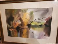 Full view of the watercolor artwork showing the impressionistic landscape with autumnal colors and a water reflection, framed and matted.