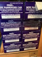 Six stacked PEEP Mini Passenger Car boxes showing front labels