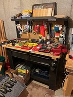 Front view of full workbench showing wooden top, pegboard and drawer configuration