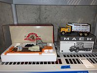 Overview of both Mack R-model vehicles in original boxes and foam inserts