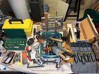 Wide view of collection showing socket set, wrenches, hand tools, chisels, and saws.