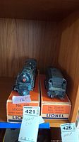 Photo showing Lionel locomotive and matching P.R.R. tender on original boxes.