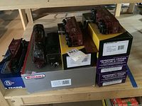 Overview of all 7 items: Williams locomotive & tender, flatcars, hopper car, crane on boxes