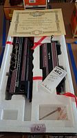 Locomotive and tender in original foam packaging with certificate visible