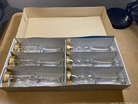 Set of six Calici flutes in original box, showing the arrangement and rim decoration
