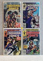 Photo of four Indiana Jones comic book covers laid out in a grid, showing varied action scenes and colourful artwork under Marvel Comics Group branding.