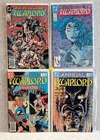 Four comics from the DC Comics series The Warlord, including main issues and an annual, laid out flat showing colorful illustrated covers.