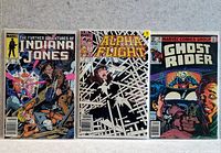 Photo of three Marvel comic books: The Further Adventures of Indiana Jones, Alpha Flight, and Ghost Rider. All comics appear in good condition with vibrant covers.