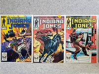 Photo of three collectible Indiana Jones comics from Marvel titled 'The Further Adventures of Indiana Jones' showing covers with action scenes and issue numbers 17, 12, 10.